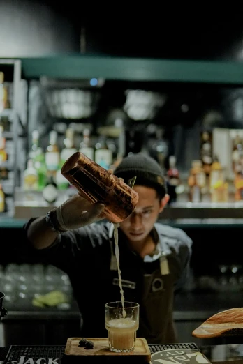 a bartender at a restaurant mixing up drink