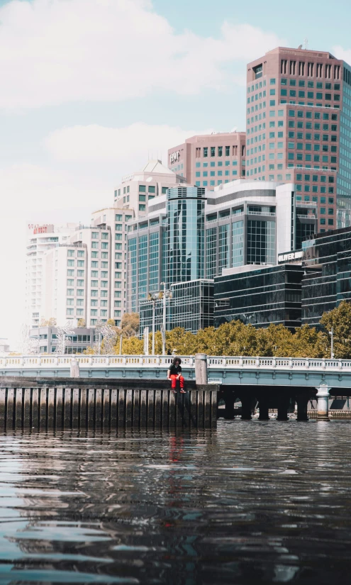 a large long bridge next to some tall buildings