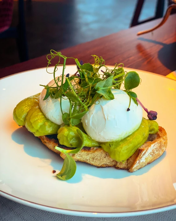 a white plate topped with an open sandwich