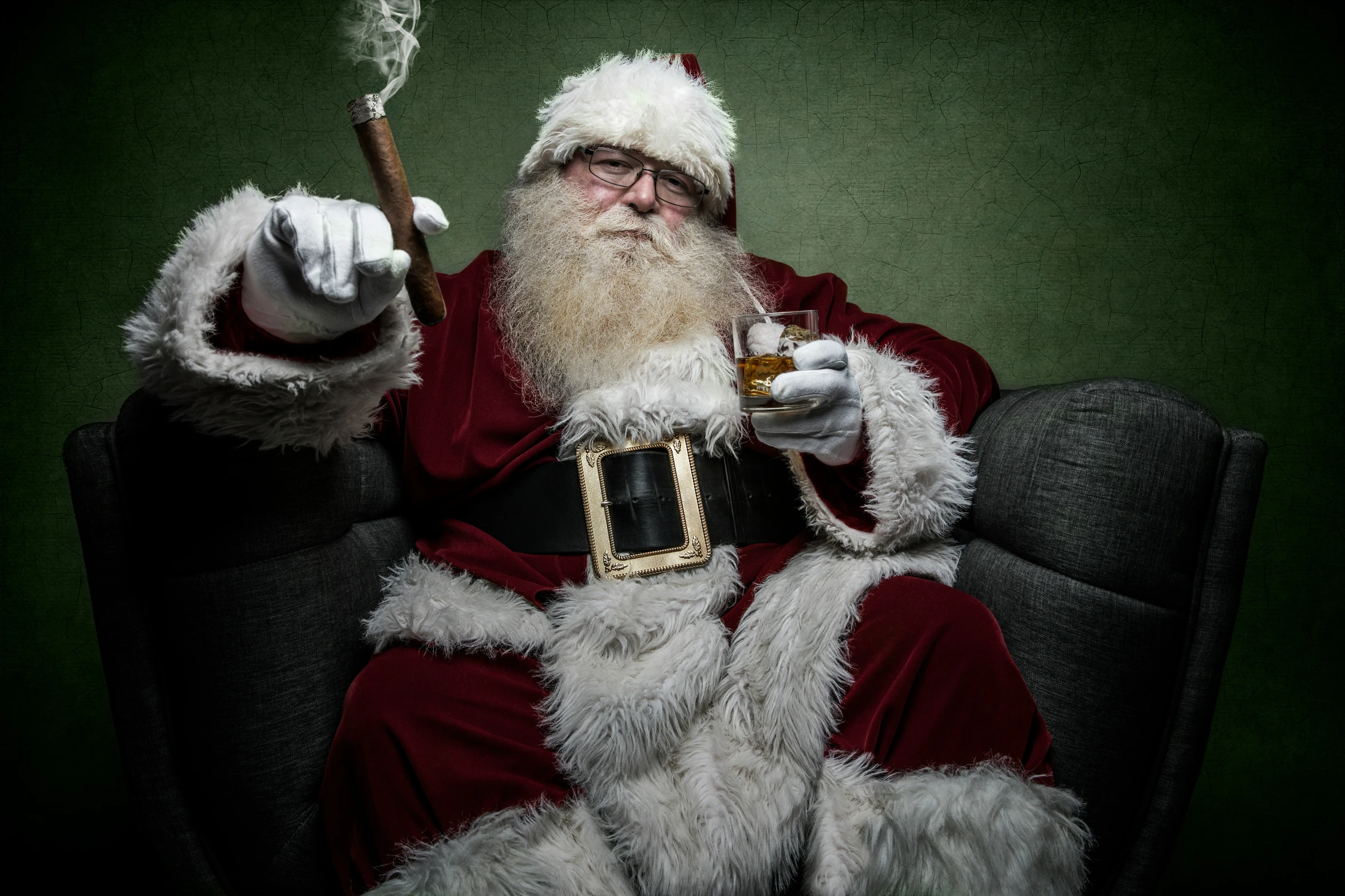 a santa claus sits in a chair holding a pipe and smoking a cigar