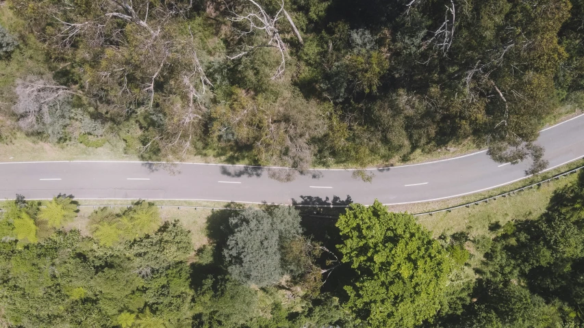 an aerial po of a long curved road