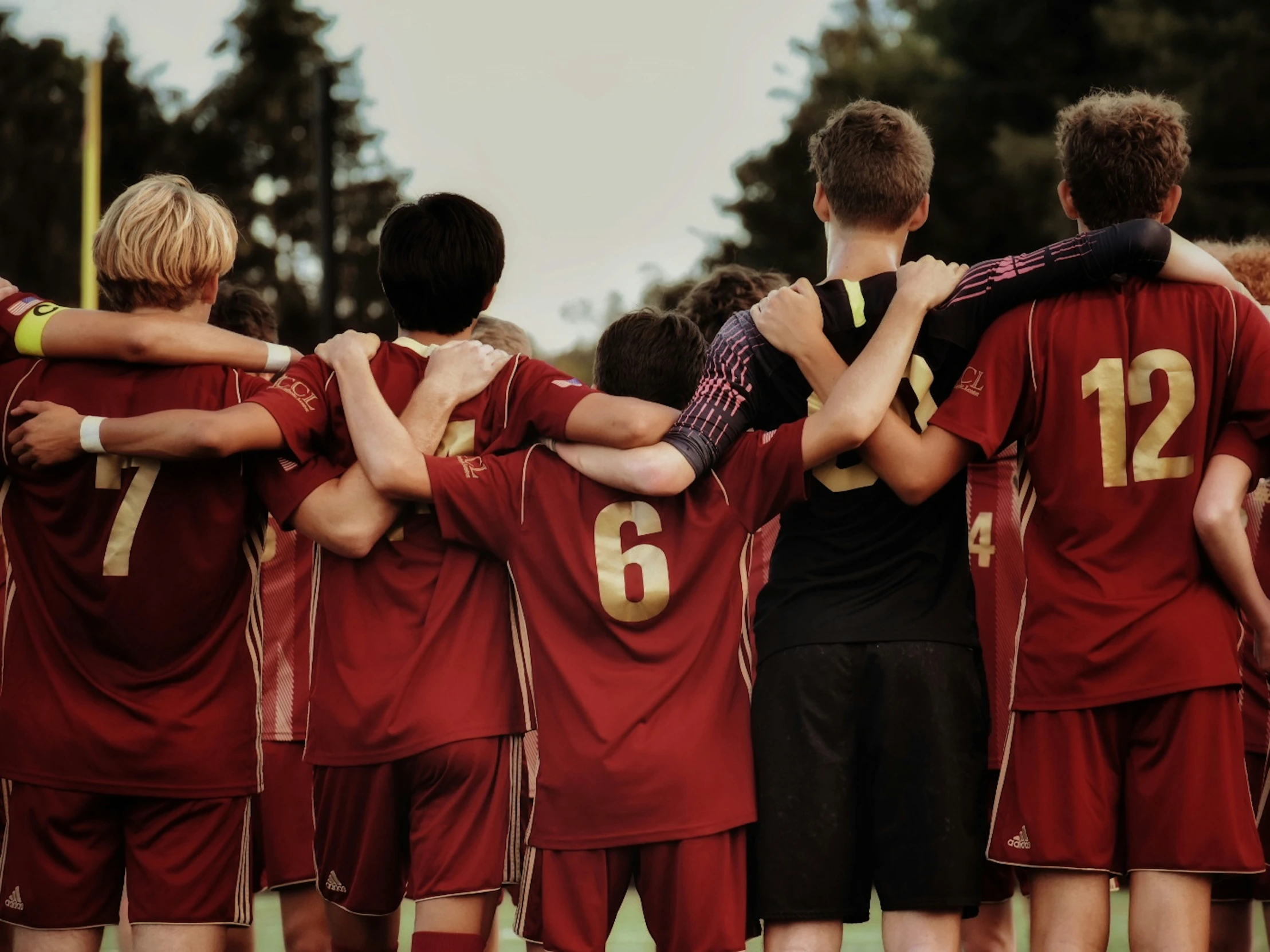 s huddled in a group after a soccer game