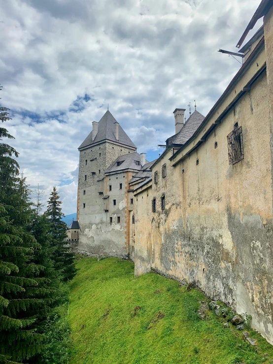 a castle with a steeple and trees in front of it