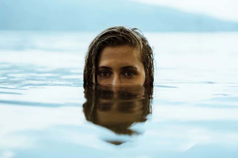 the woman's head is submerged in water