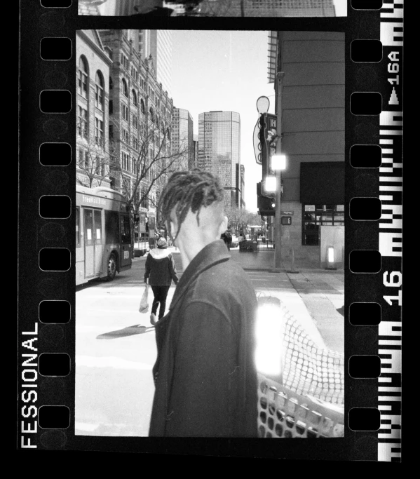 a man in a suit looking back at the street