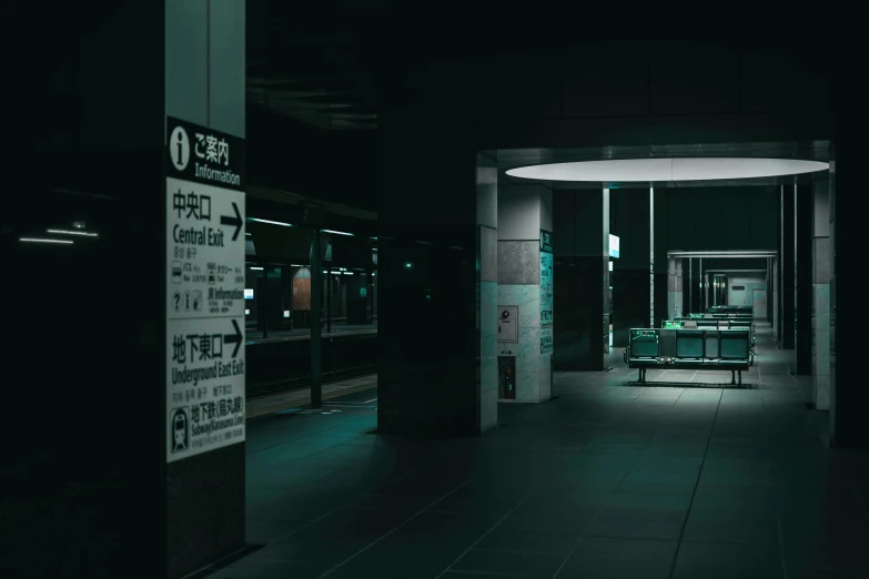 a long dark hallway with a sign in the foreground