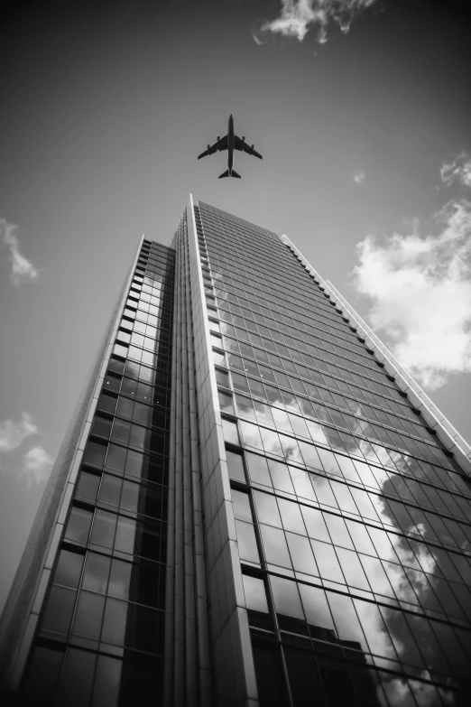 an airplane flying in the air from a high rise