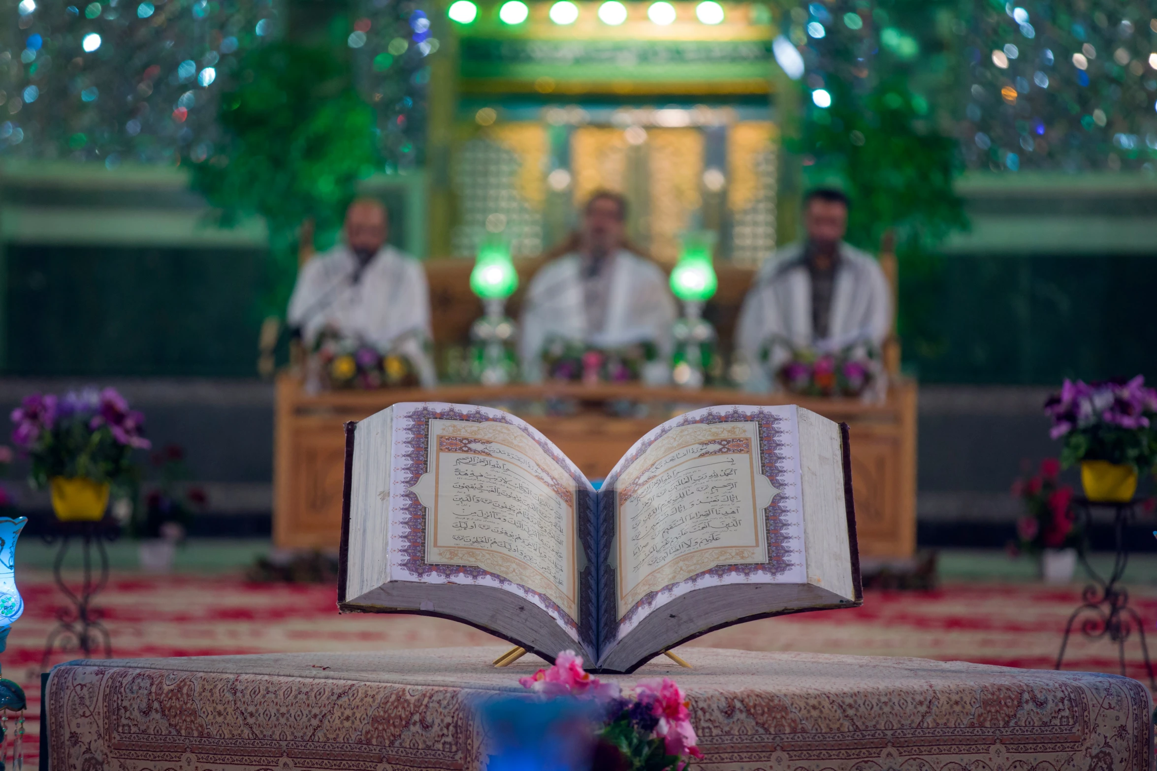 a book opened on the ground in front of a priest