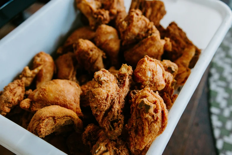 fried food in a white tray on a table