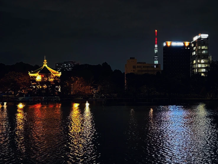 a city skyline over looking a lake at night