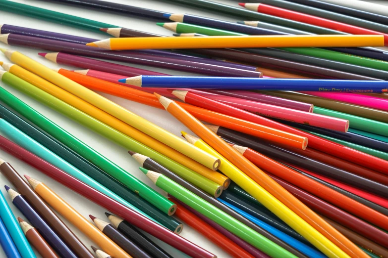 colorful pencils all lined up together in a row