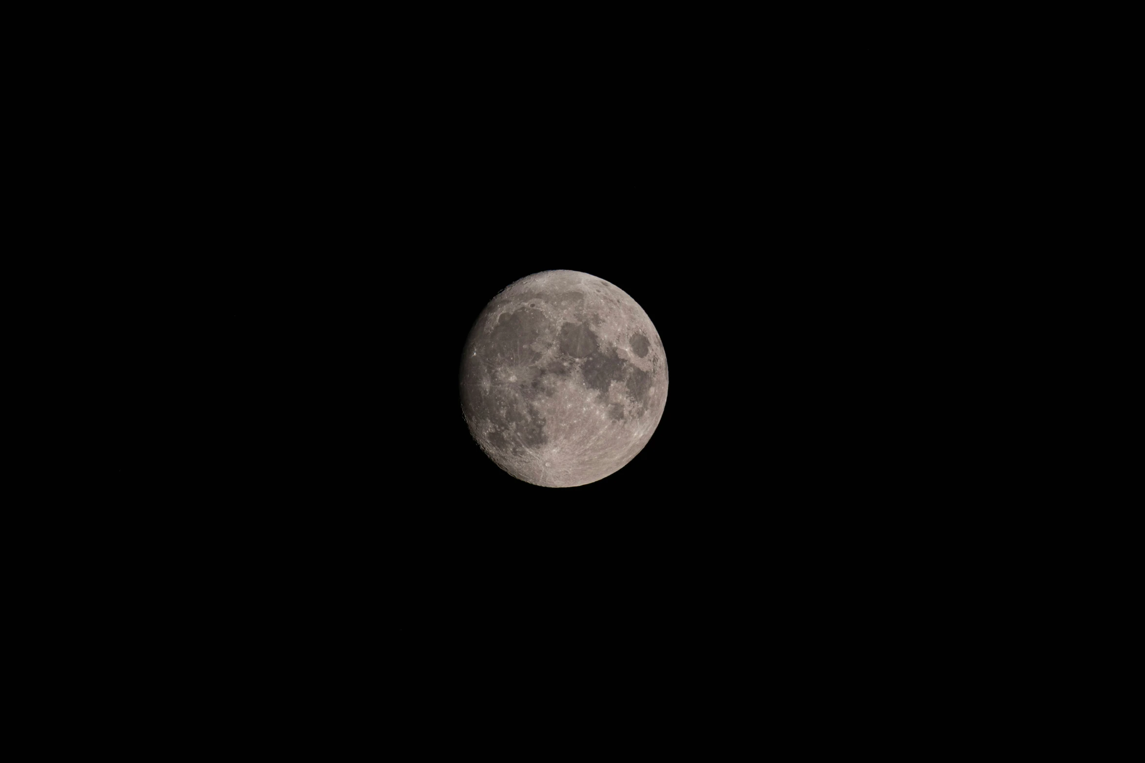 a full moon seen in the sky from below