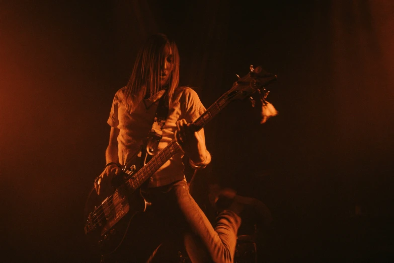 a man on stage playing guitar with a microphone