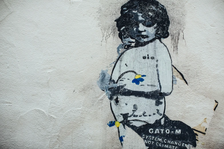 the graffiti on the wall depicts a child wearing diapers and holding a baseball bat