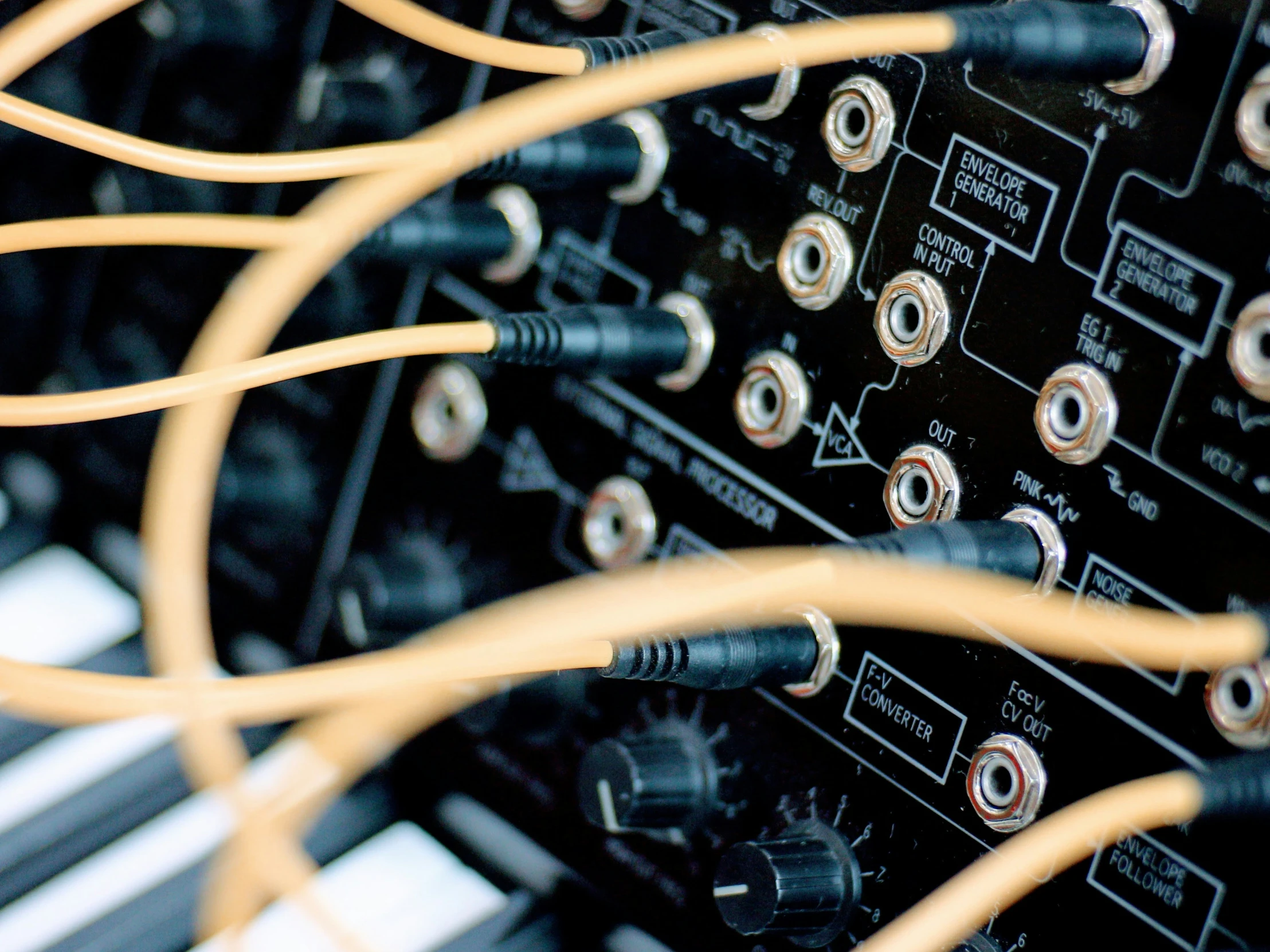 many wires connected to electronic equipment on a black surface