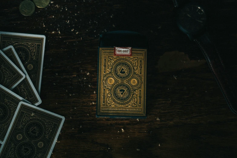 a set of playing cards on the floor next to playing chips