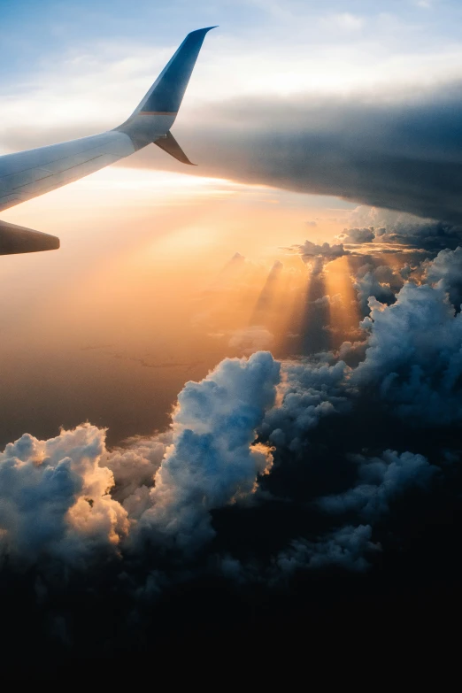 a view from the window of a plane flying over clouds