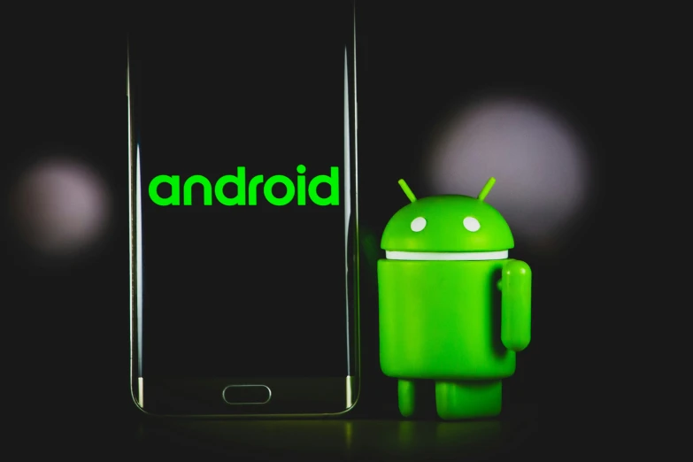 a green android figure next to a cell phone