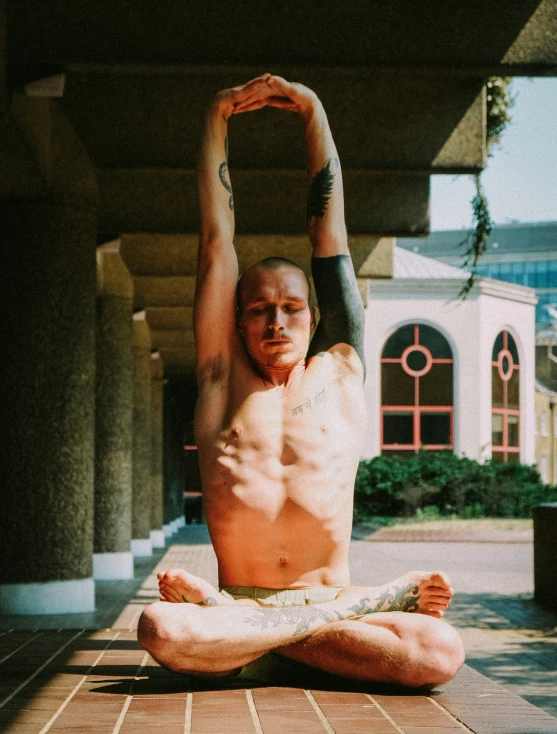 a man with his feet crossed in the middle of a yoga position