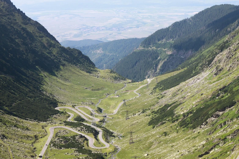 a winding road on a mountain side surrounded by trees