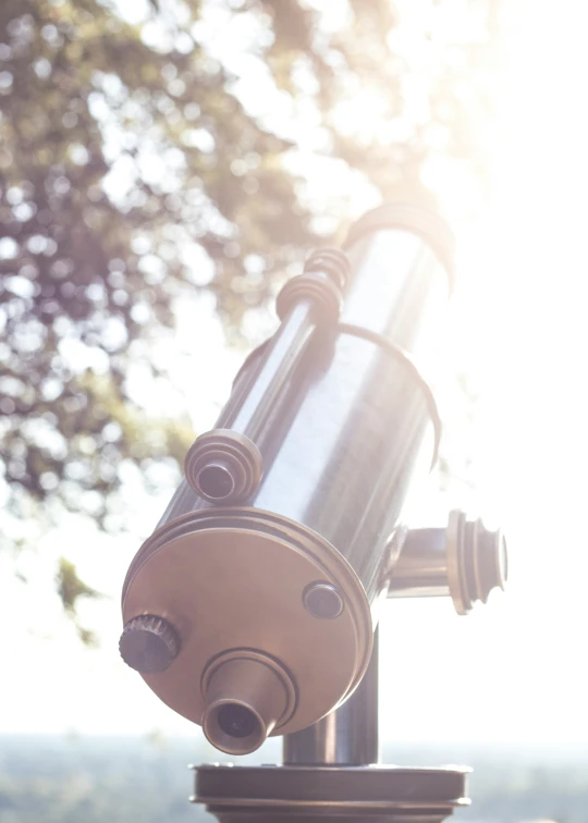 close up of a telescope mounted on top of a pillar