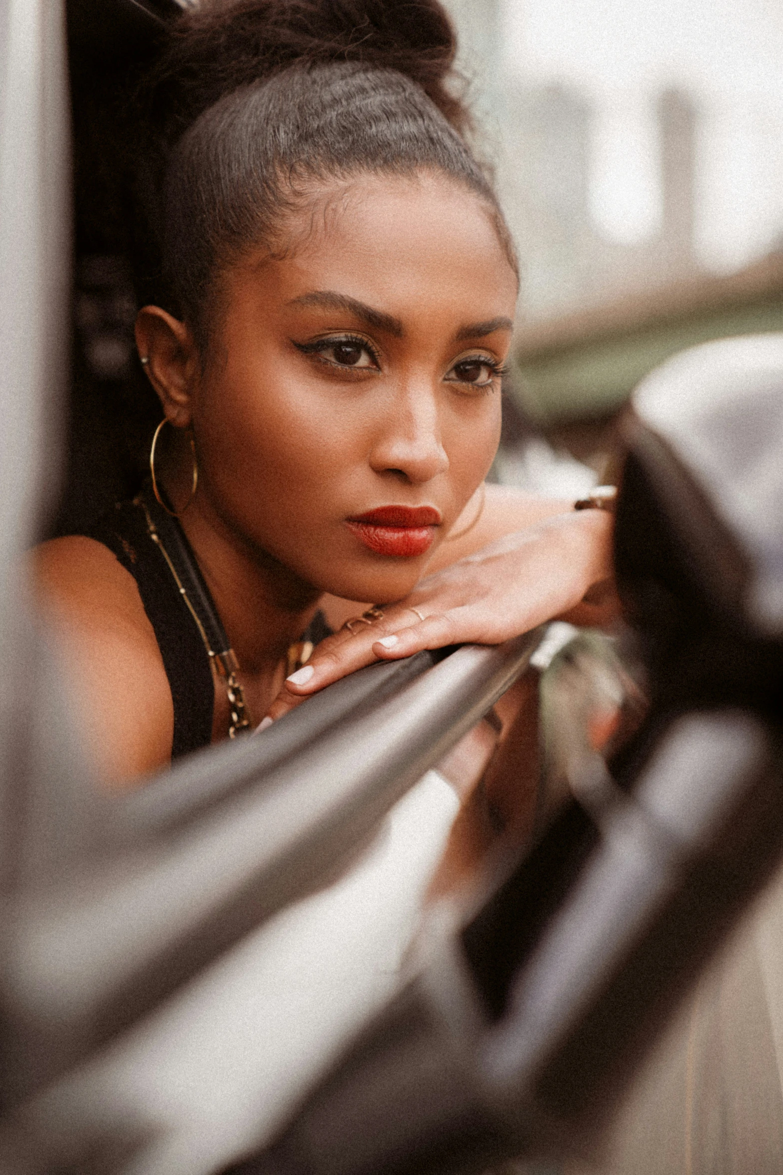 a woman leans against a metal railing