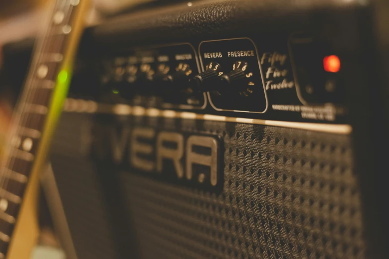 an amplifier with a black handle sits in a room