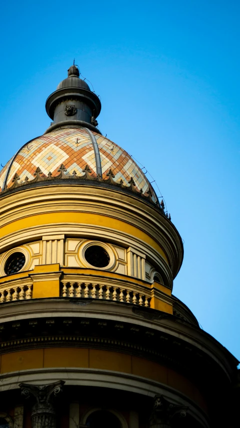 the top of a building is seen against the blue sky