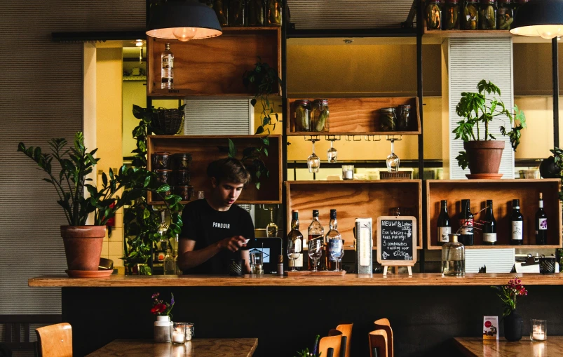 the man is working behind the bar