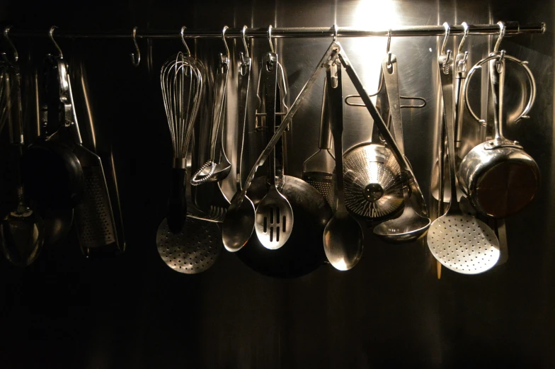 a kitchen with some spoons hanging from it