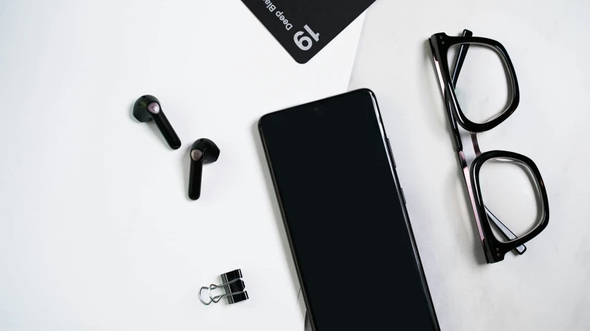 a pair of glasses sitting next to a black case