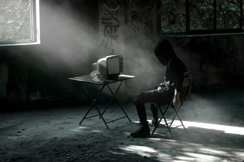 man sitting in a chair with an open suitcase