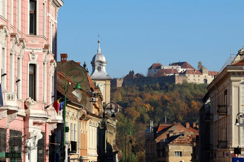 a city street with houses in the distance