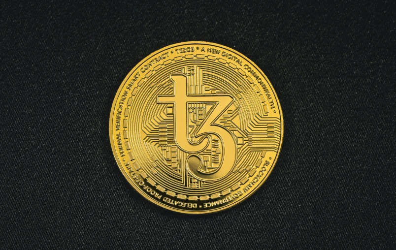 a gold coin with the number twenty five on it