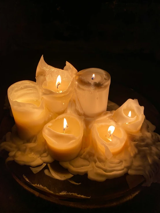 a bunch of lit candles are sitting in a bowl