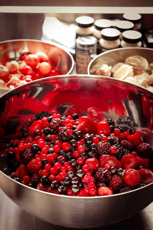 fresh berries and other foods being prepared in pots