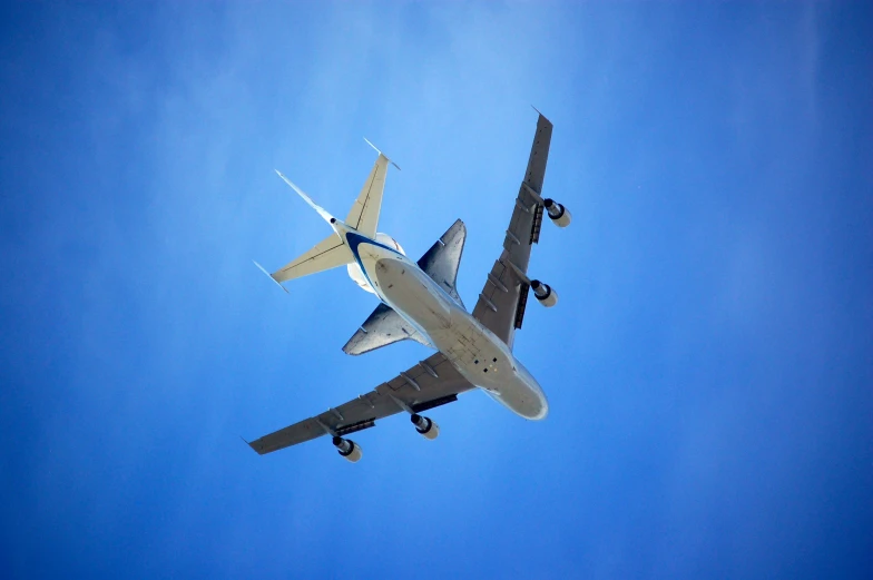 the plane is flying through the blue sky