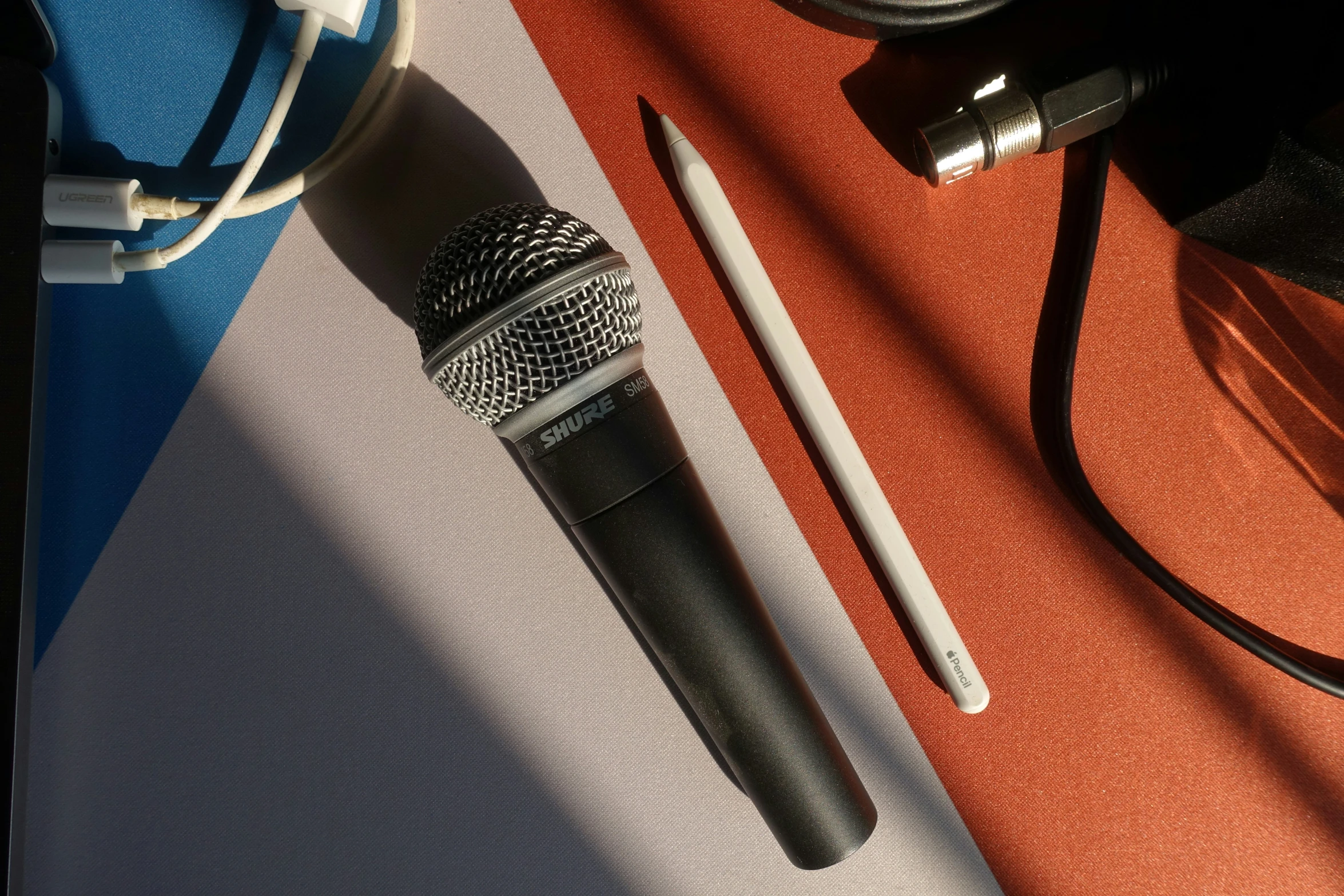 a microphone is sitting on a table near some headphones