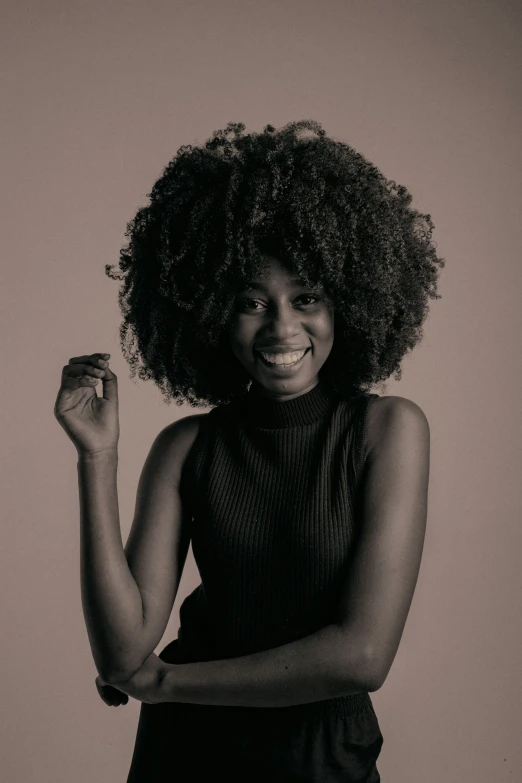 an african american woman in black with afro hair