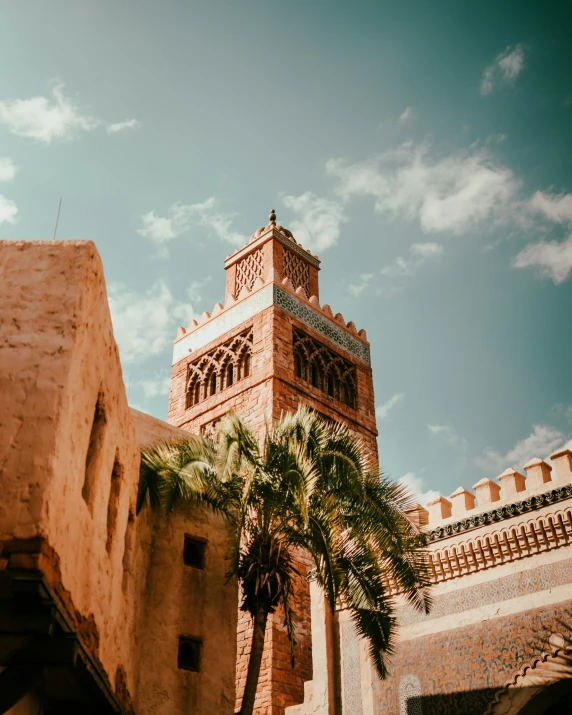 a tall brick clock tower in a courtyard