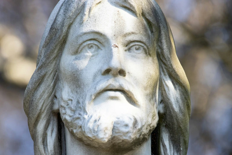 a statue of jesus with his head turned backwards