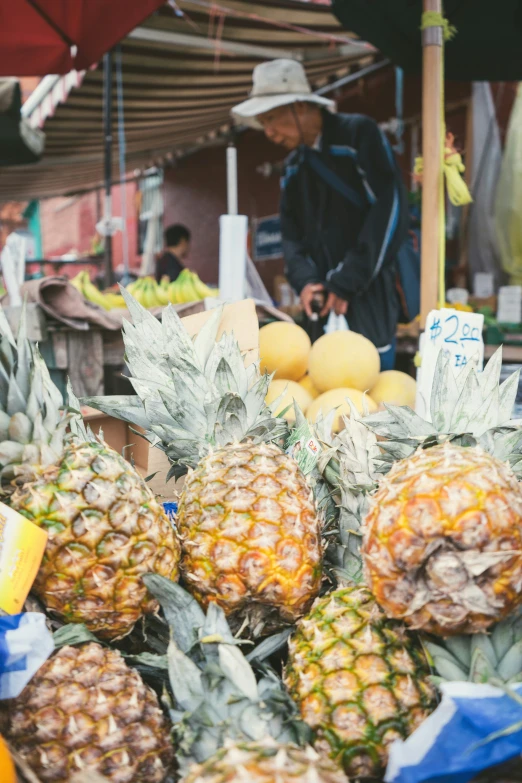 a man standing in front of a fruit stand