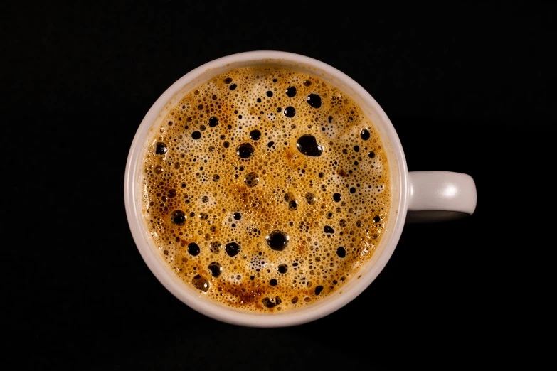 a cup full of liquid on a table