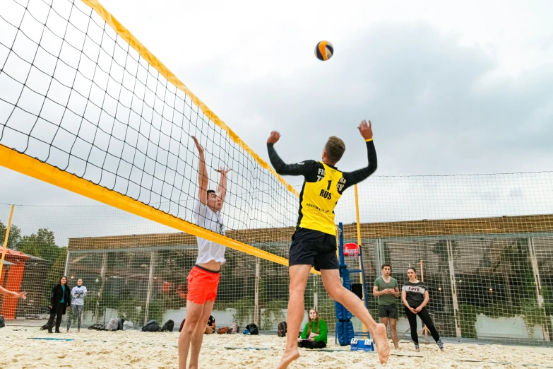 the volleyball players are playing volleyball on the beach