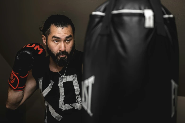 a boxer posing for the camera, in his ring boxing outfit