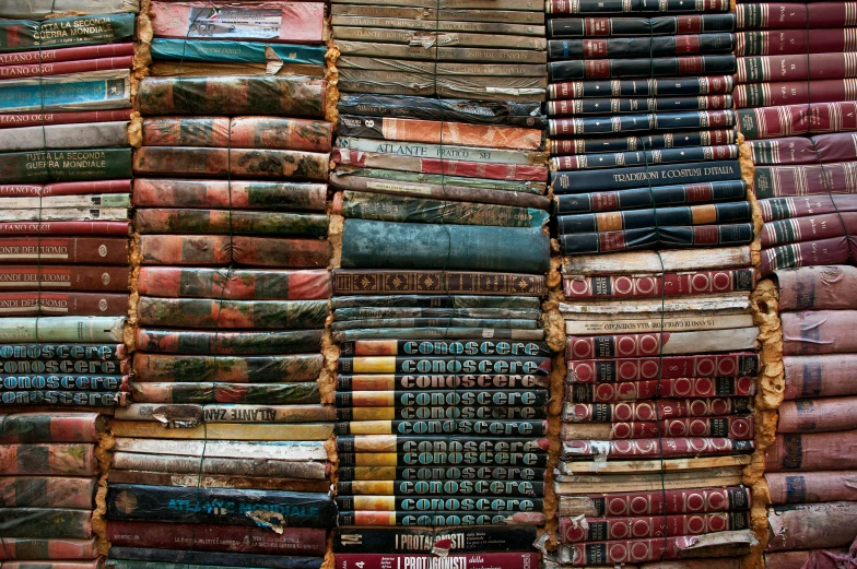 a huge pile of old books are stacked up