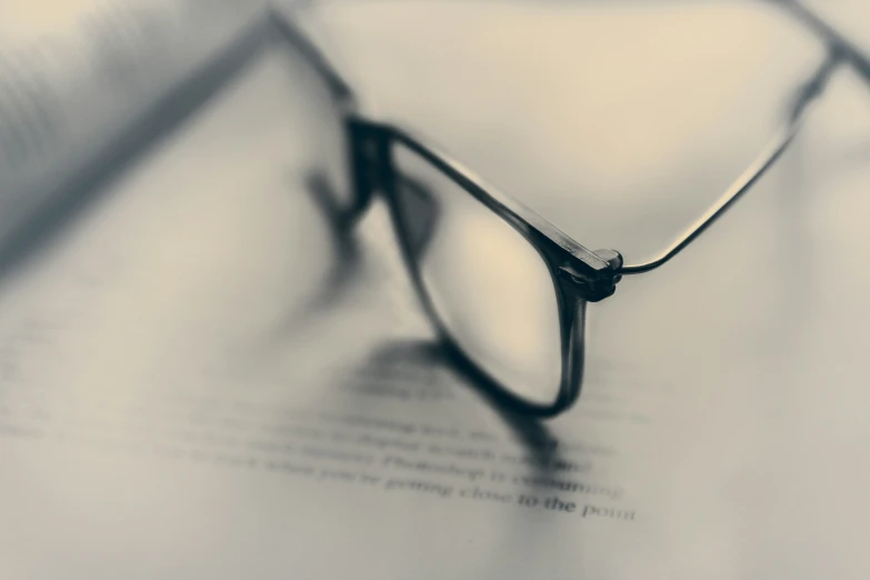 a pair of glasses on top of a book