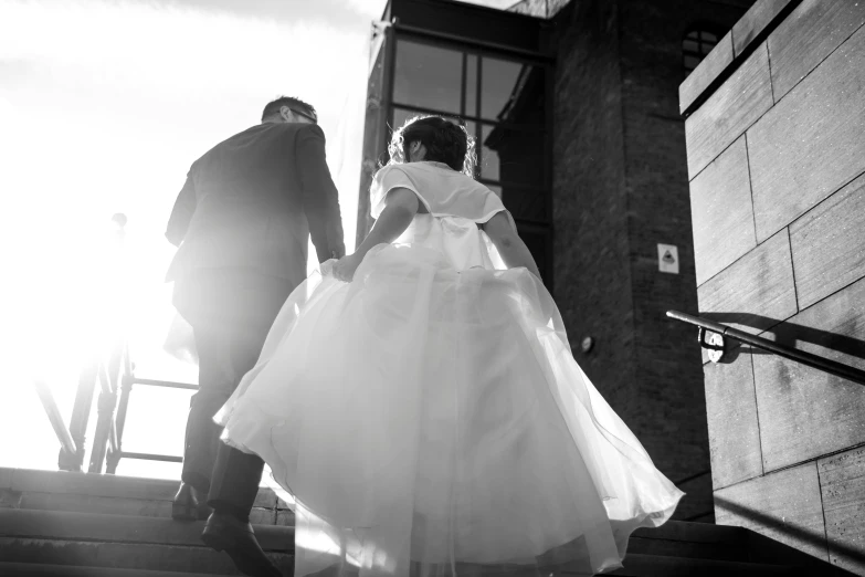 man and woman walking down a set of stairs