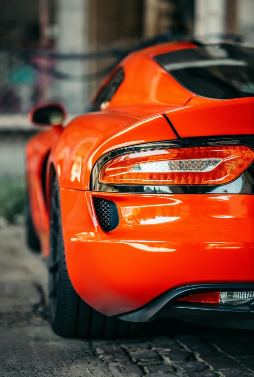 the back end of an orange sports car