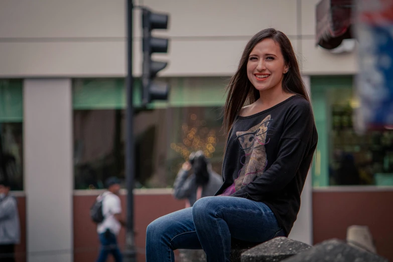 a woman sitting on top of a rock